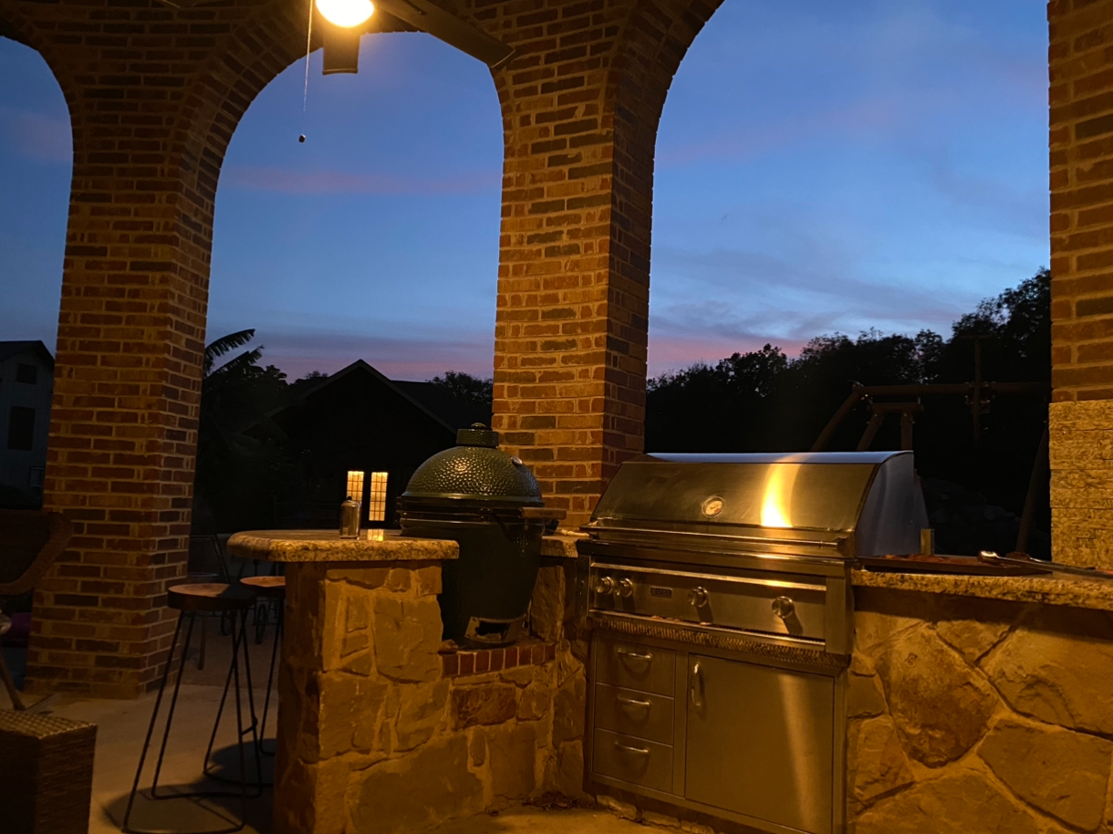 Custom covered arched brick patio with grilling station